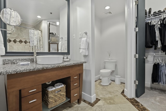 full bathroom featuring visible vents, toilet, a spacious closet, and vanity