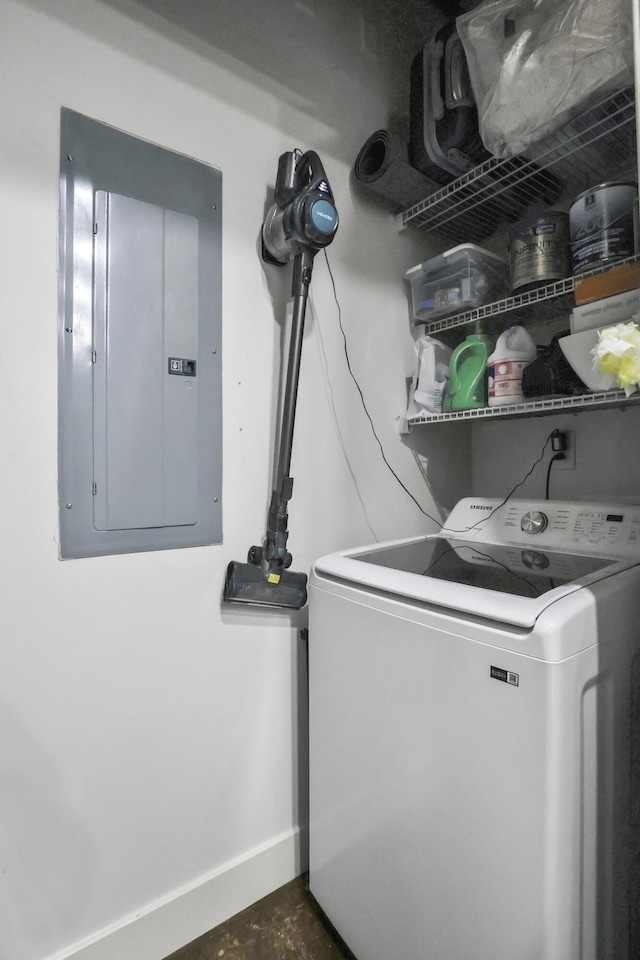 washroom with washer / dryer, baseboards, electric panel, and laundry area