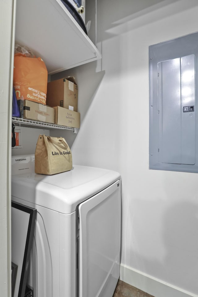 laundry area with laundry area, washer and clothes dryer, electric panel, and baseboards