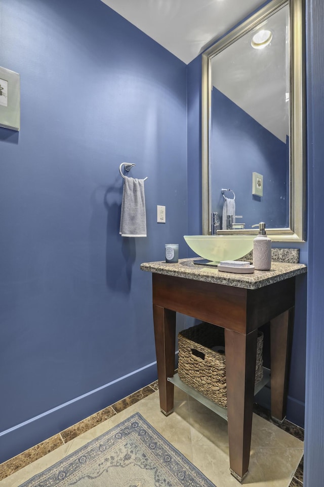 bathroom featuring baseboards and vanity