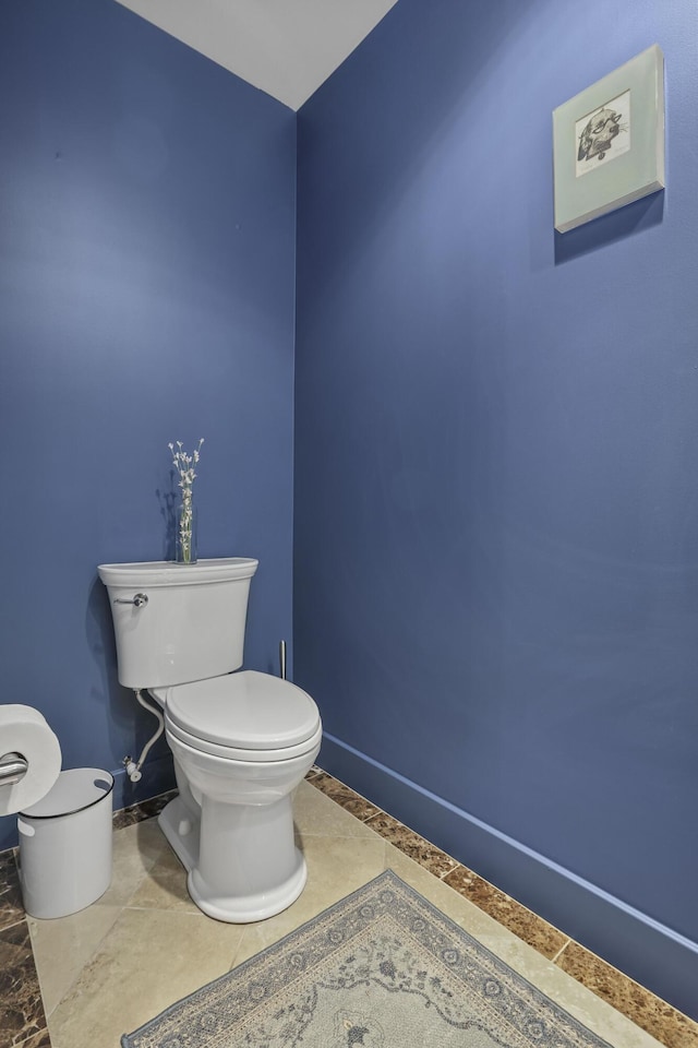 bathroom featuring toilet and baseboards