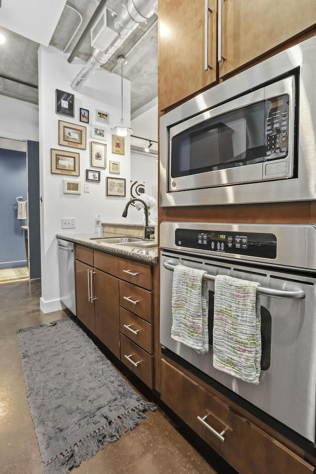 kitchen with finished concrete flooring, visible vents, light stone countertops, stainless steel appliances, and a sink