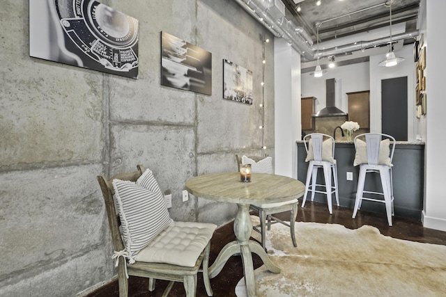 dining room with a high ceiling and wood finished floors