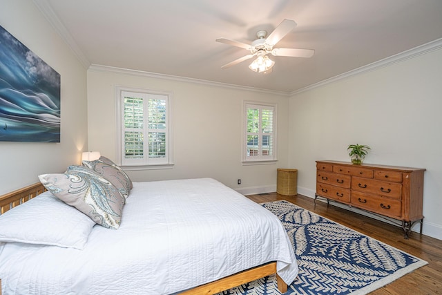 bedroom featuring crown molding, a ceiling fan, baseboards, and wood finished floors