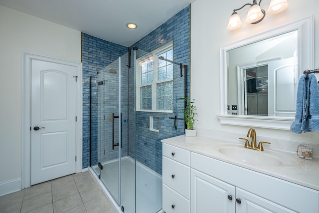bathroom featuring vanity, recessed lighting, tile patterned floors, and a tile shower