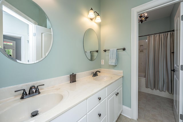 bathroom with double vanity, a sink, a shower with shower curtain, and tile patterned flooring