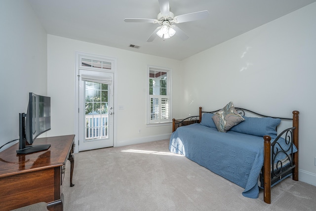 carpeted bedroom featuring baseboards, ceiling fan, access to exterior, and visible vents