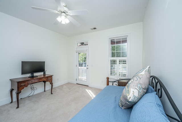 carpeted bedroom featuring visible vents, a ceiling fan, baseboards, and access to exterior