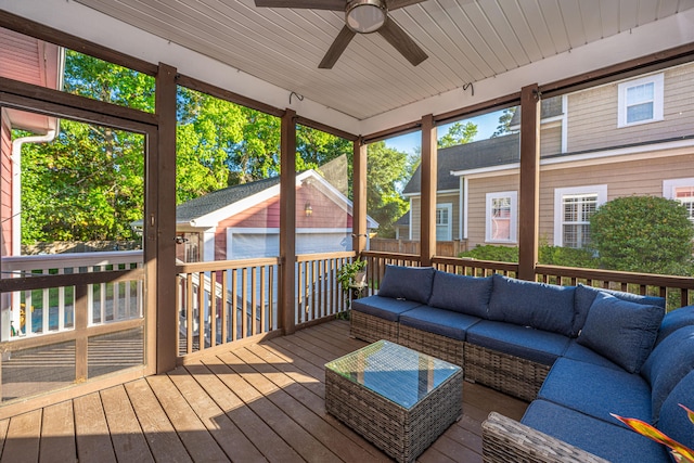 sunroom / solarium featuring a ceiling fan and an outdoor hangout area