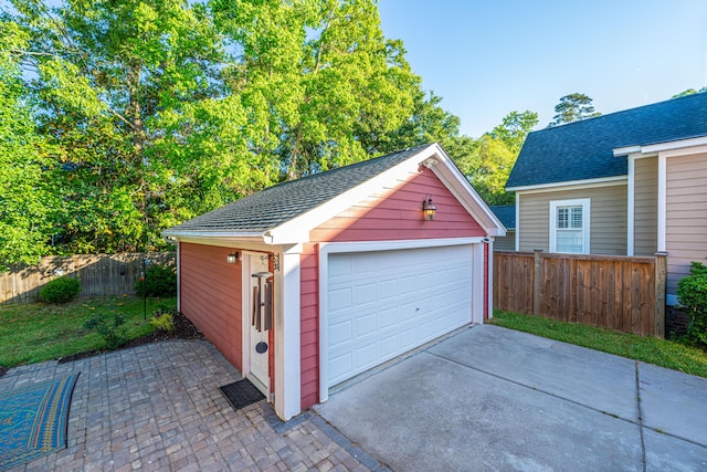detached garage featuring fence