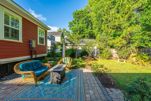 view of patio / terrace featuring a fenced backyard and an outdoor living space with a fire pit