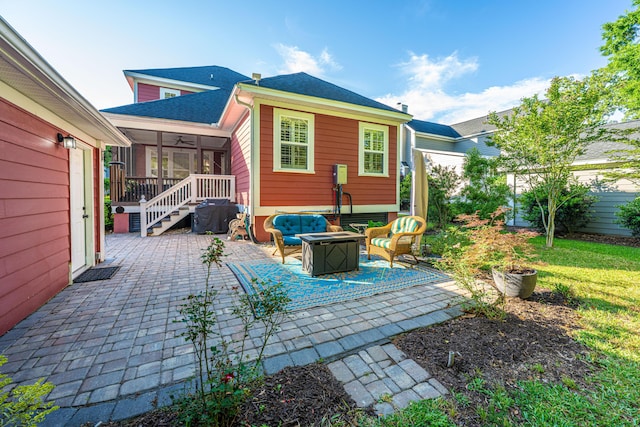 back of property featuring fence, roof with shingles, a sunroom, a patio area, and a fire pit
