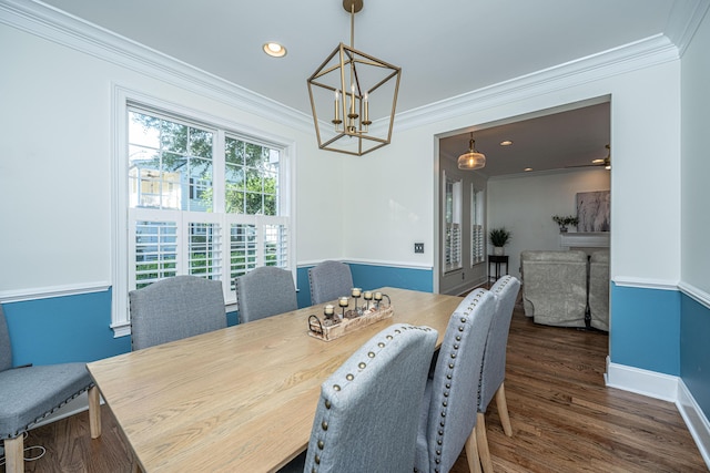 dining space with baseboards, an inviting chandelier, ornamental molding, and wood finished floors