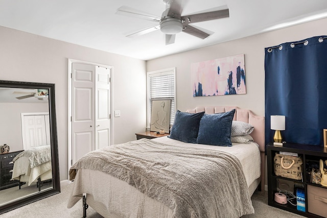 carpeted bedroom featuring ceiling fan and a closet