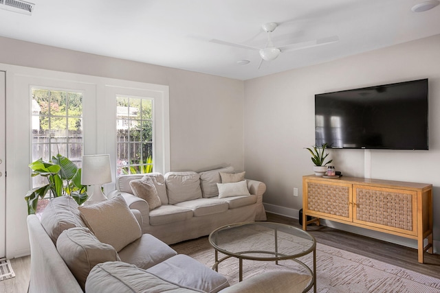 living room featuring ceiling fan and hardwood / wood-style floors