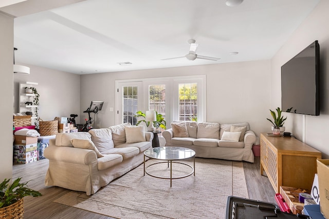 living room with hardwood / wood-style flooring and ceiling fan