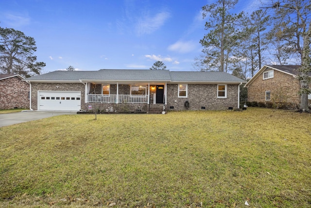 ranch-style house featuring a porch, a garage, and a front yard