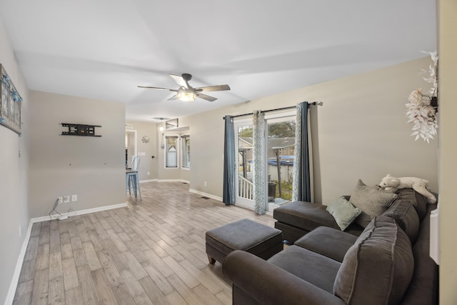 living room featuring ceiling fan and light wood-type flooring