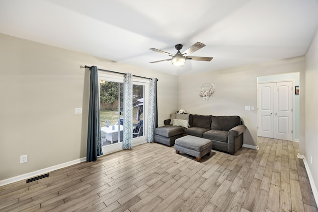 living room featuring ceiling fan and light wood-type flooring