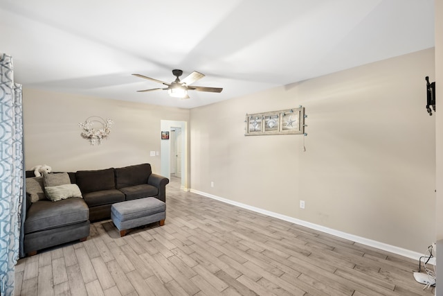 living room featuring ceiling fan and light hardwood / wood-style flooring