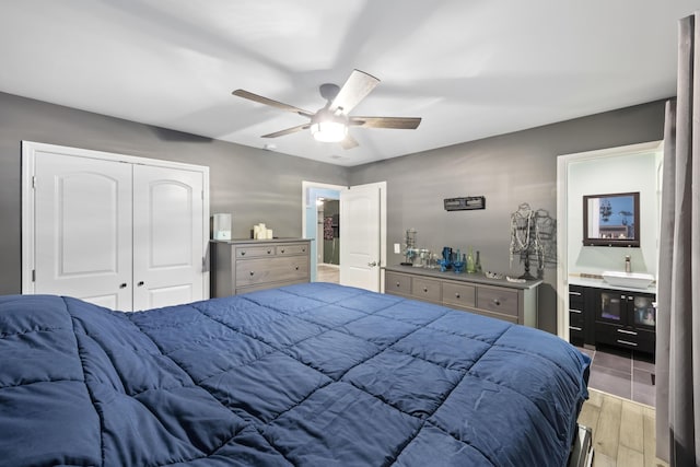 bedroom with ceiling fan, a closet, and light wood-type flooring