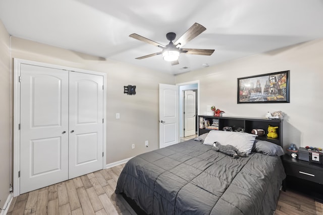 bedroom featuring light hardwood / wood-style flooring, a closet, and ceiling fan