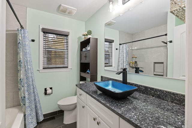 full bathroom with vanity, shower / tub combo, tile patterned floors, and toilet