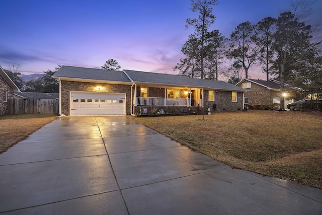 ranch-style house featuring a porch and a garage