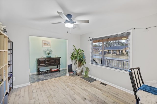 sitting room featuring ceiling fan and light wood-type flooring