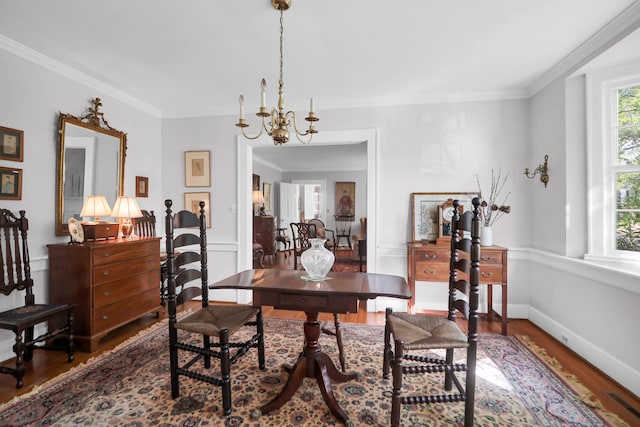 office with an inviting chandelier, crown molding, wood finished floors, and baseboards