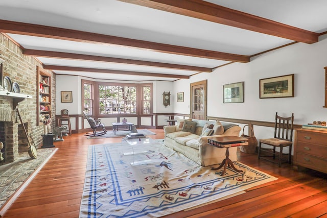 living area featuring wood-type flooring and beam ceiling