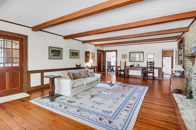 living area featuring wainscoting, beam ceiling, and wood-type flooring