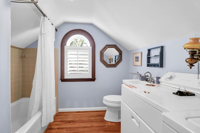 full bath with wood finished floors, vanity, toilet, lofted ceiling, and shower / bath combo with shower curtain