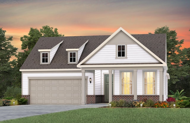 view of front of home featuring driveway, brick siding, a shingled roof, and a front lawn
