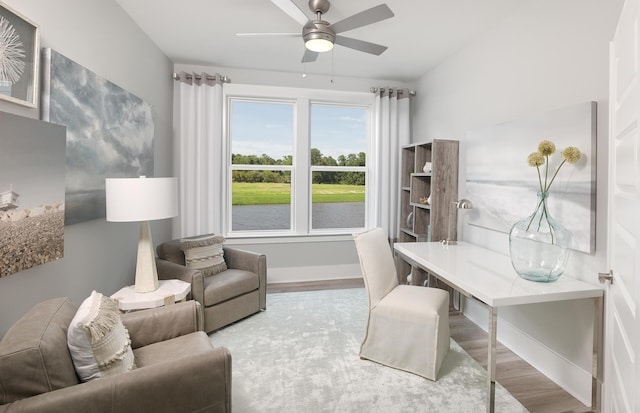 office featuring baseboards, wood finished floors, and a ceiling fan