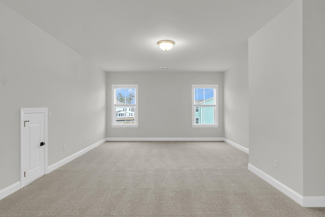 unfurnished room featuring baseboards, carpet, and a healthy amount of sunlight