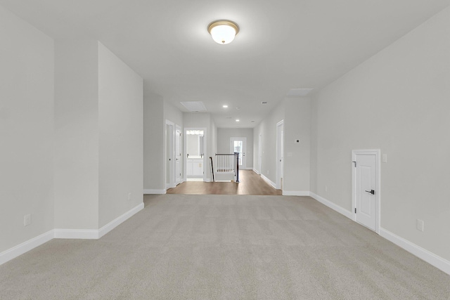 carpeted empty room featuring recessed lighting and baseboards