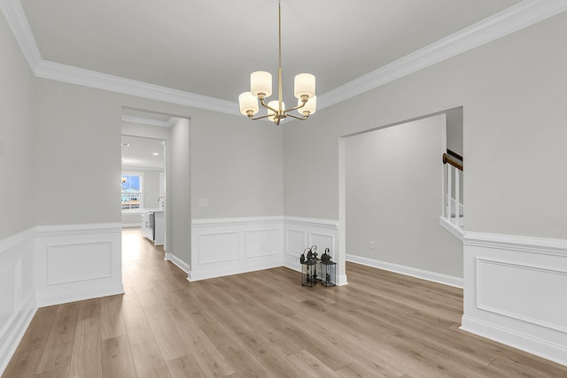 unfurnished dining area featuring a decorative wall, stairs, ornamental molding, light wood finished floors, and an inviting chandelier