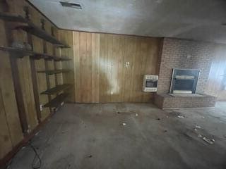 495 Majority Rd, Orangeburg, SC 29118 - unfurnished living room with wood walls, a fireplace, and heating unit