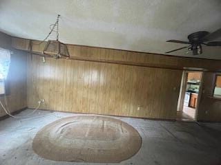 495 Majority Rd, Orangeburg, SC 29118 - spare room with wood walls, concrete flooring, and a ceiling fan