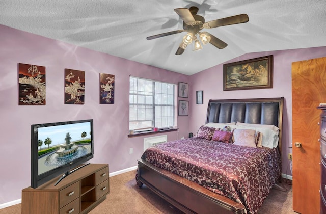 carpeted bedroom with a textured ceiling, ceiling fan, and vaulted ceiling