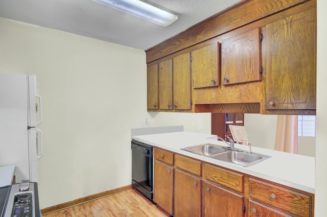 kitchen featuring dishwasher, light wood-type flooring, white fridge, and sink