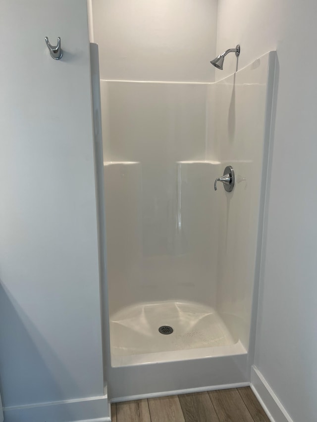 bathroom featuring a shower and wood-type flooring