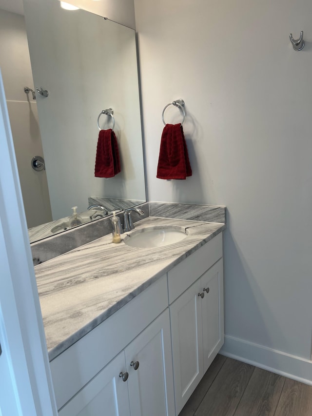 bathroom with vanity and hardwood / wood-style flooring