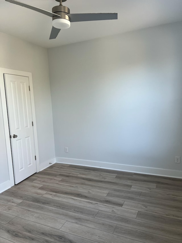 empty room featuring hardwood / wood-style flooring and ceiling fan