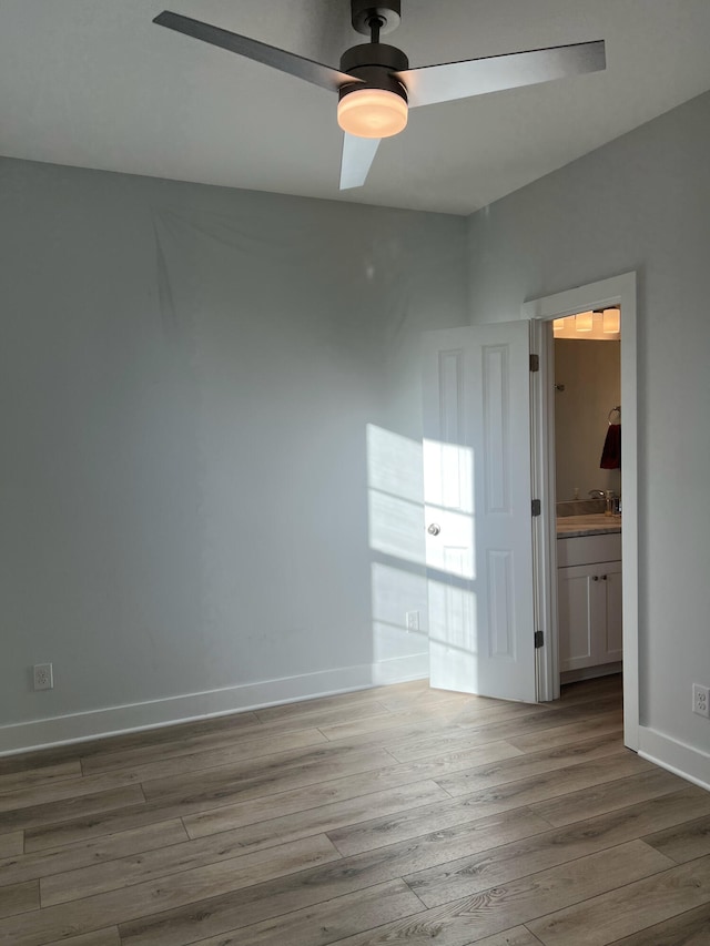 unfurnished room with hardwood / wood-style flooring, sink, and ceiling fan