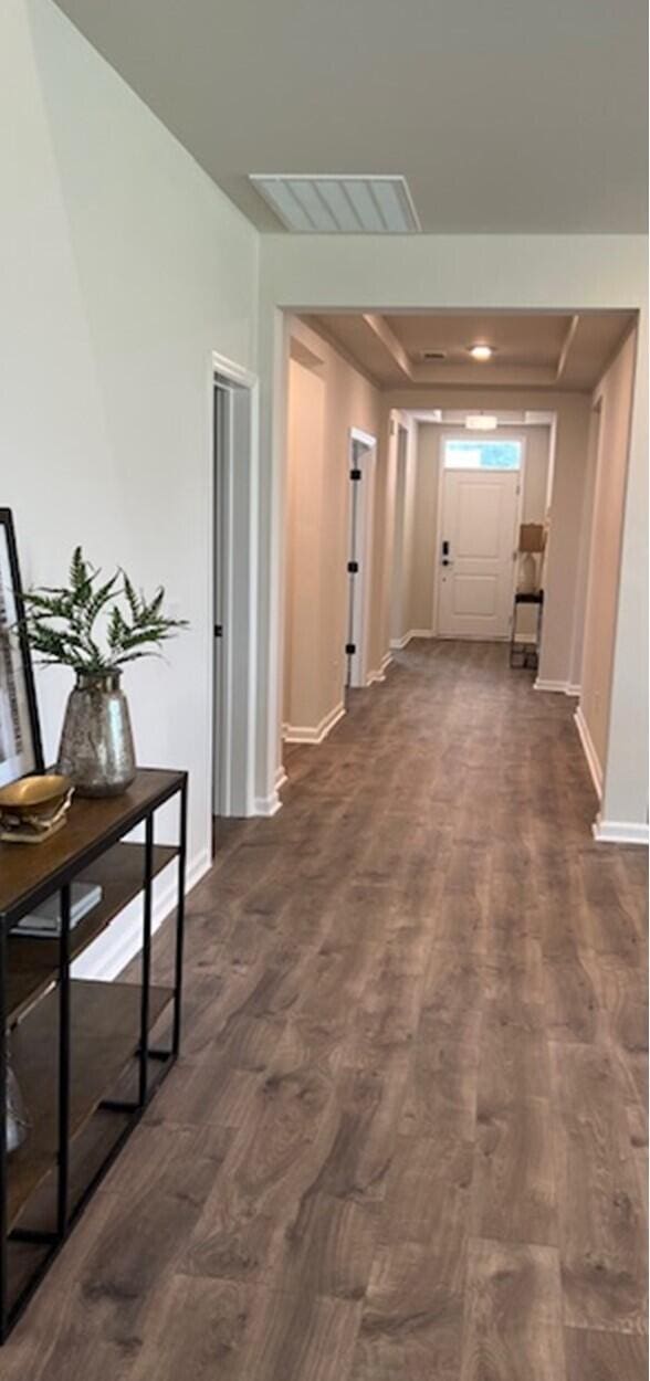 corridor featuring dark hardwood / wood-style flooring