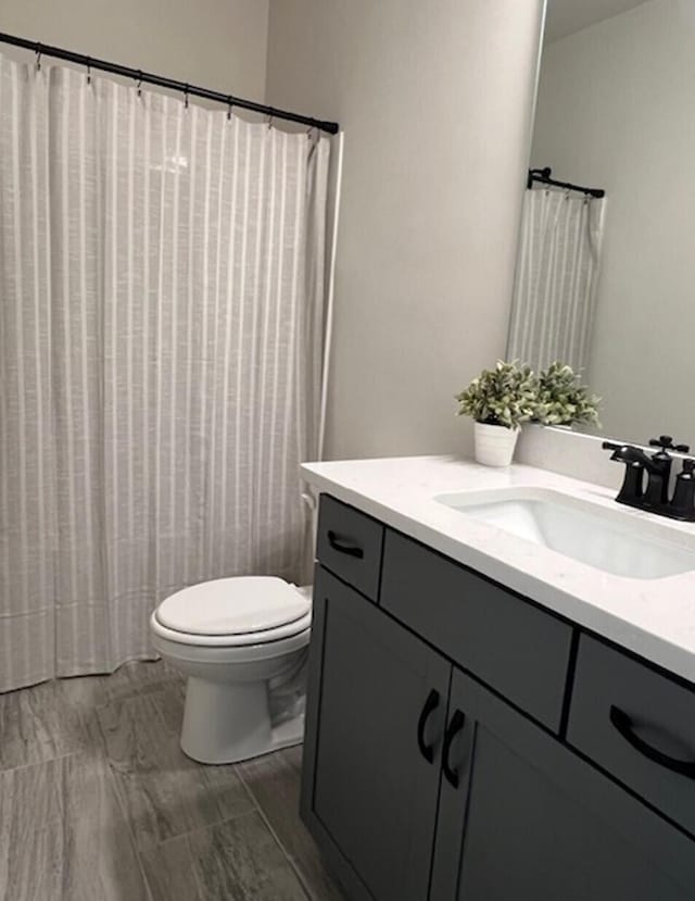 bathroom featuring vanity and toilet