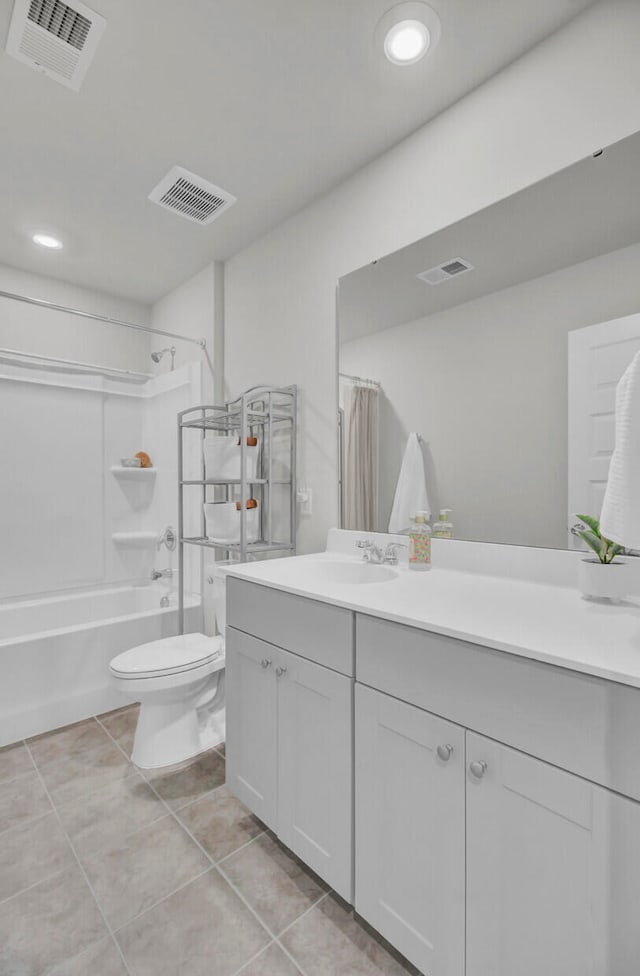 full bathroom featuring toilet, tile patterned flooring, vanity, and shower / tub combo