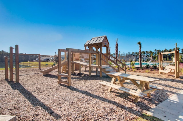 view of jungle gym featuring a swimming pool